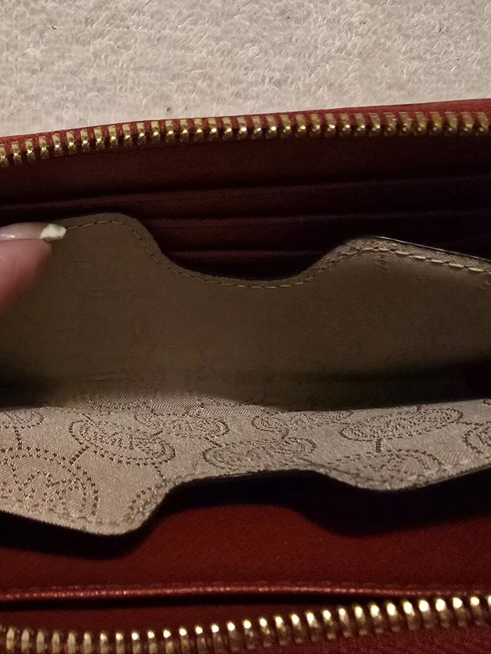 Michael Kors Red ostrich-patterned zip-around wallet featuring 1981 Goldtone